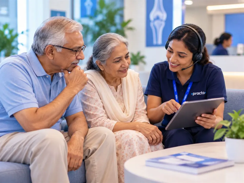 A Practo care expert explaining knee replacement options to an elderly couple